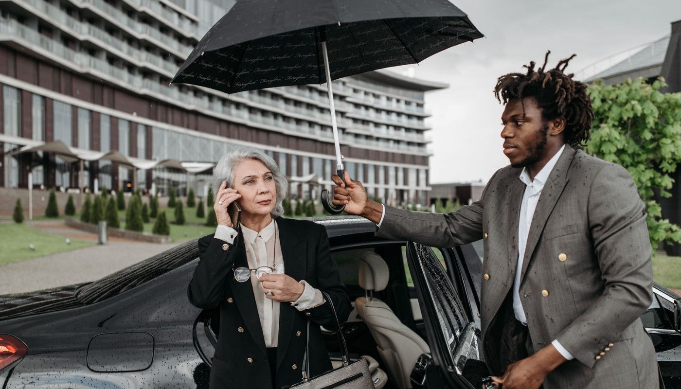 Chauffeur escorting a traveler at airport pickup