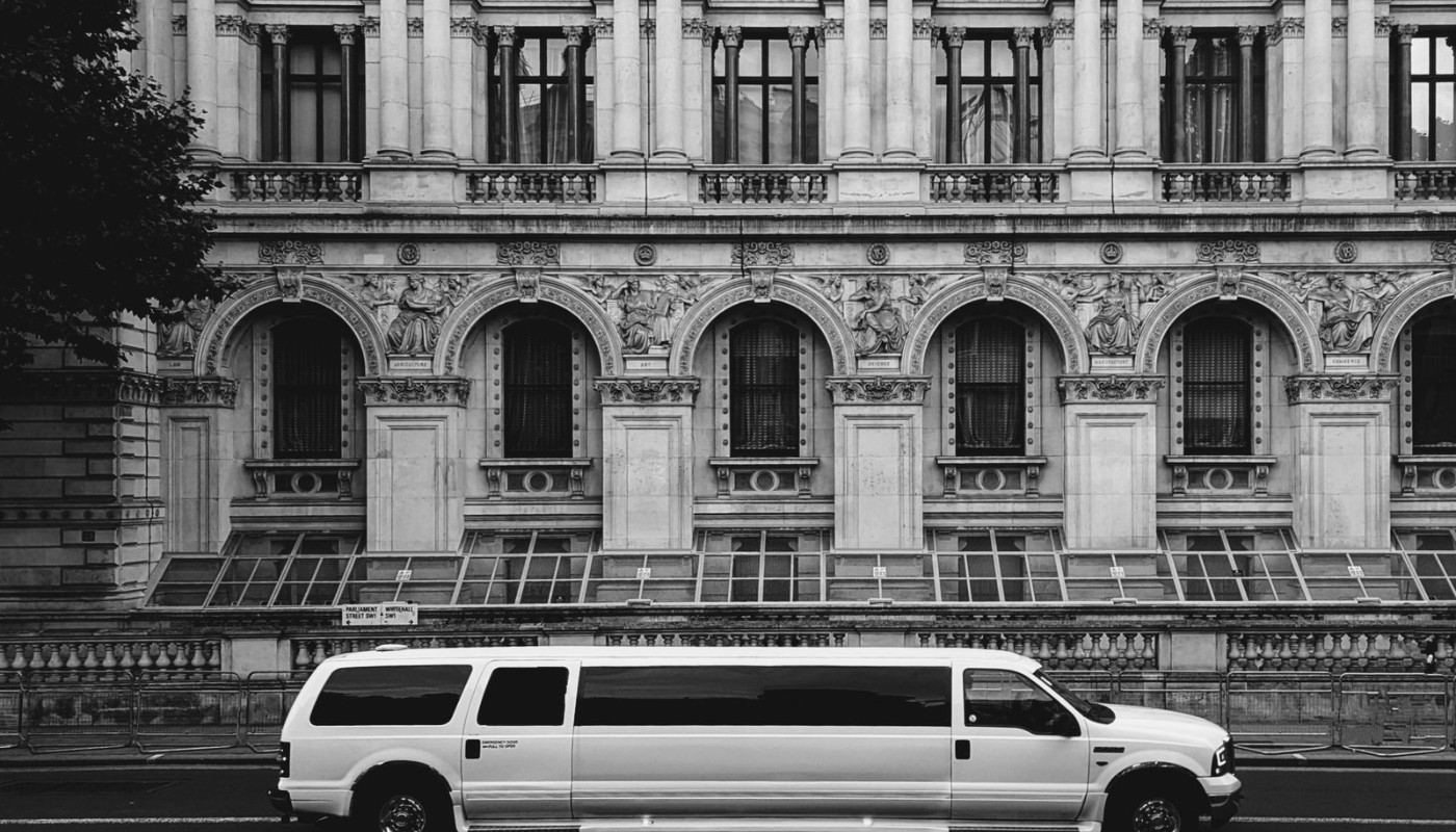 Limousine parked in front of an elegant event venue