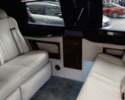 Interior of a luxury limousine with white leather seating