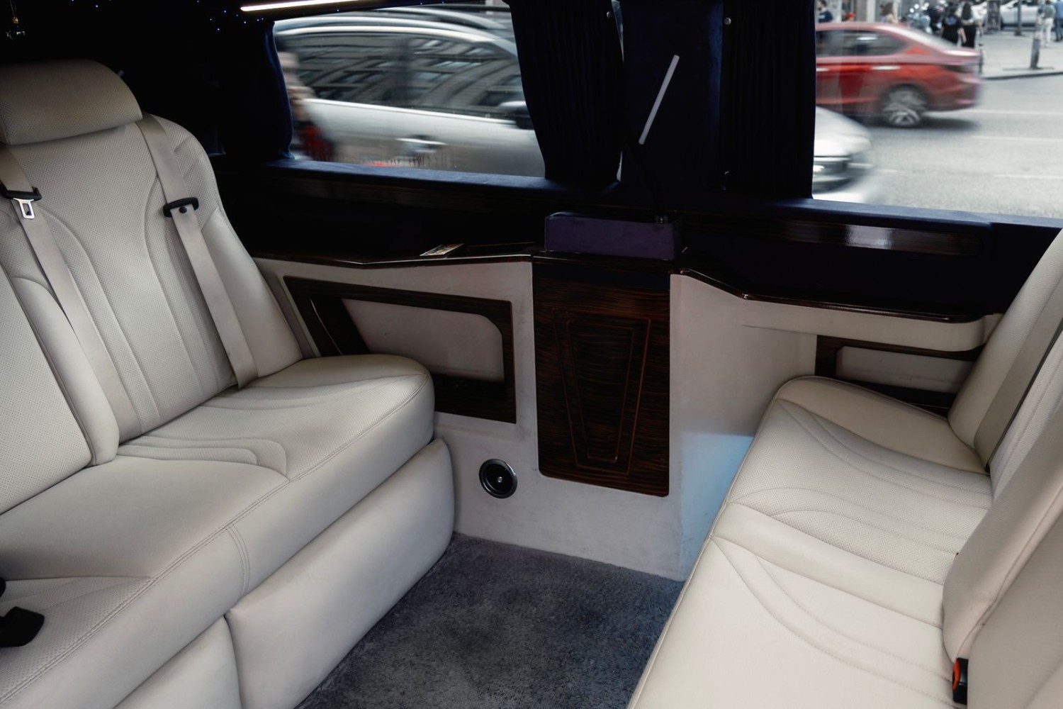 Interior of a luxury limousine with white leather seating