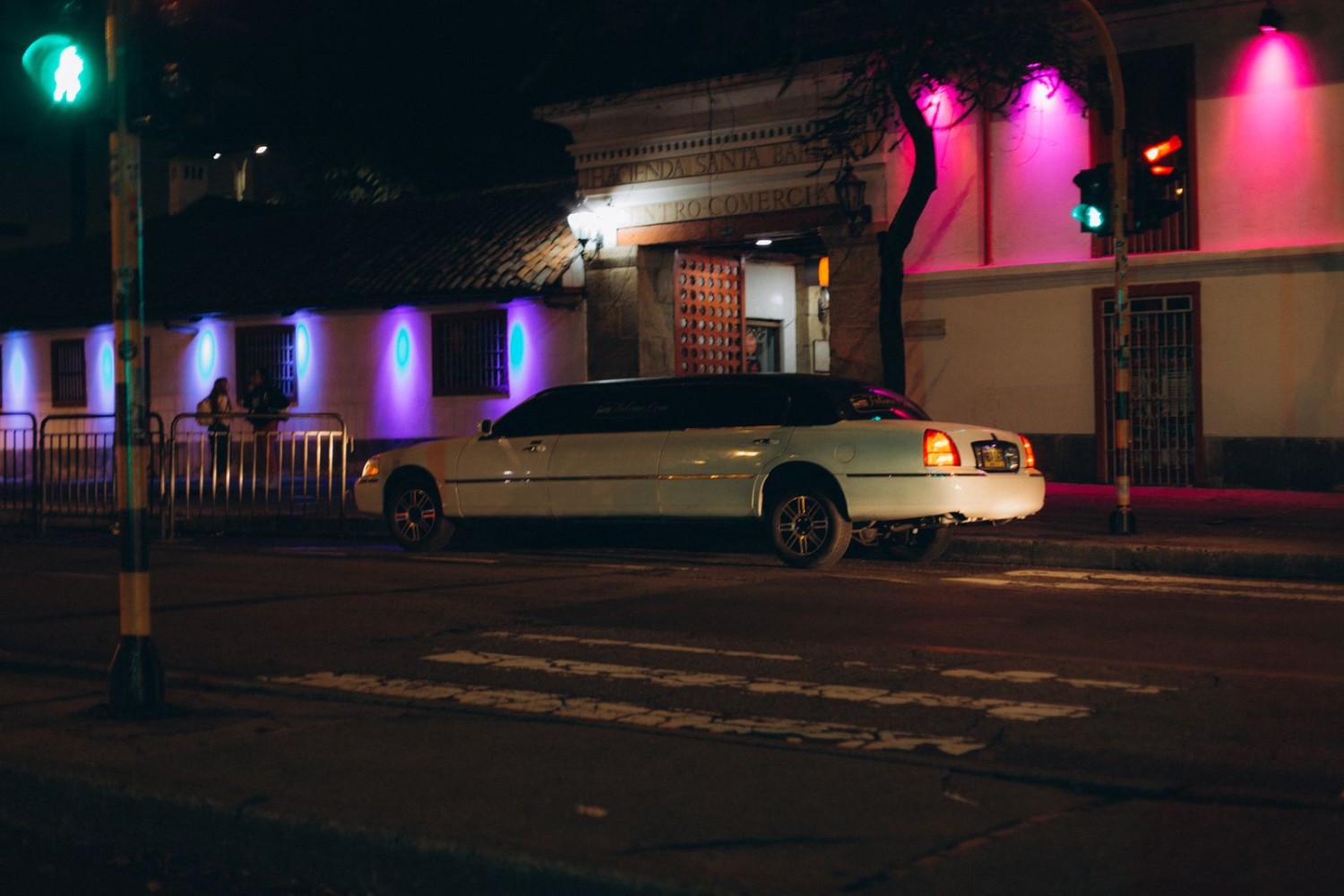 White stretch limousine on a city street at night